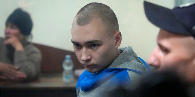 Sargento en el ejército ruso.  Vadim Shishimarin, de 21 años, se ve detrás de un vidrio durante una audiencia en la corte en Kyiv, Ucrania, el miércoles 18 de mayo.  Fue condenado a cadena perpetua por el asesinato de un civil desarmado.