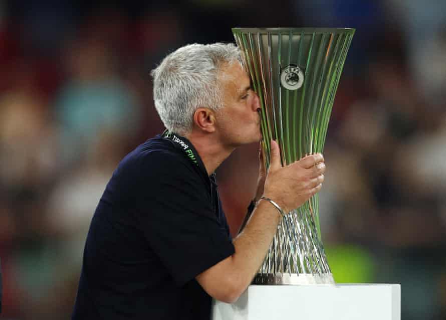 Roma manager Jose Mourinho celebrates with the trophy after winning the Europa Conference League.